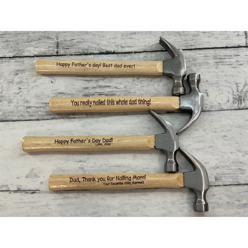 May include: Four miniature hammers with wooden handles and engraved messages. The messages include "Happy Father's day! Best dad ever!", "You really nailed this whole dad thing!", "Happy Father's Day Dad! Love, Alex", and "Dad, Thank you for Nailing Mom! Your favorite child, Kermet".