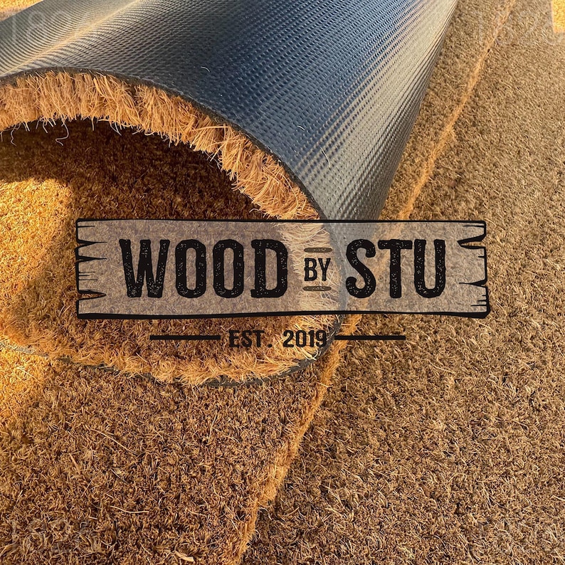 a close-up of a textured surface, possibly a carpet or mat, with a logo or text overlay in the center.