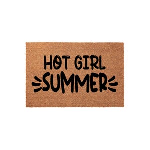 A textured area rug with the phrase "HOT GIRL SUMMER" printed on it.