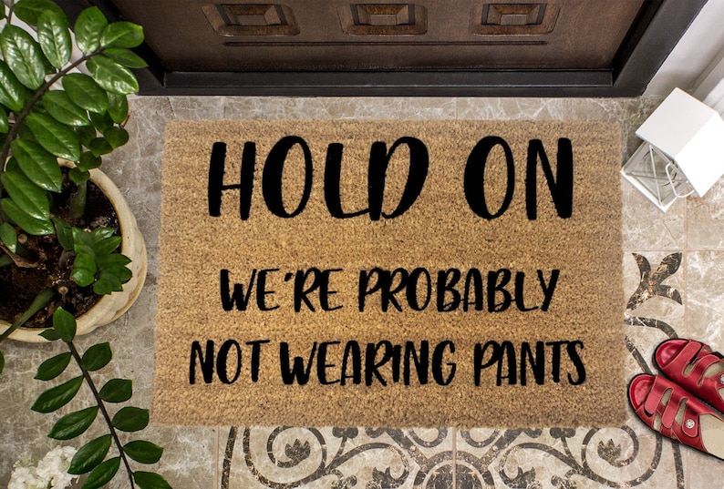 Hold On We're probably not wearing pants Funny Doormat image 0