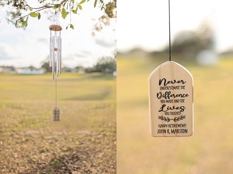 May include: A wooden wind chime with a tag that reads "Never underestimate the difference you made and the lives you touched. Happy Retirement! John R. Marston". The wind chime is hanging from a tree branch.