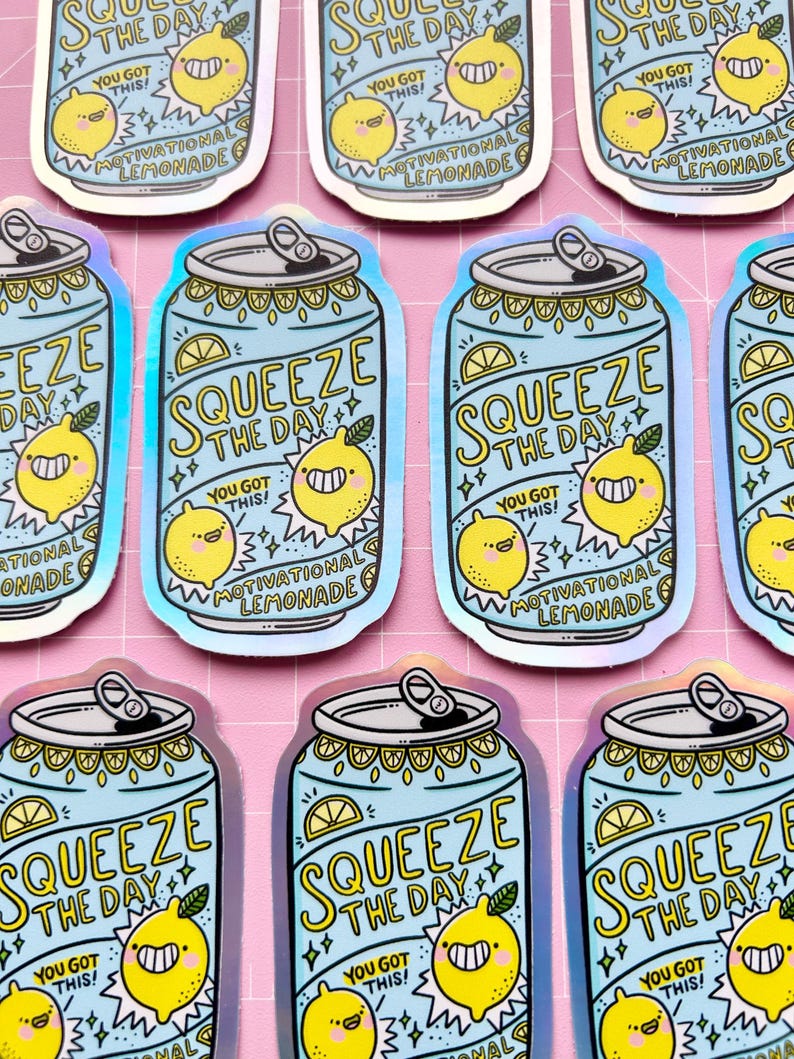 May include: A set of nine holographic stickers featuring a blue can with a yellow lemon and the text "Squeeze the Day! You Got This! Motivational Lemonade".