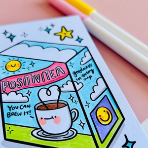 May include: A hand-drawn illustration of a box of tea labelled "Positivitea" with a cup of tea and the text "You can brew it!" and "goodness in every cup". The illustration is surrounded by stars and a sun.