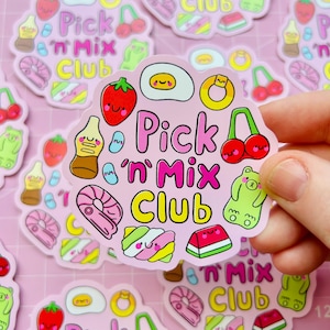 May include: A pink sticker with the text "Pick 'n Mix Club" and various cartoon candies and fruits. The sticker features a strawberry, cherry, gummy bear, and other colorful treats.