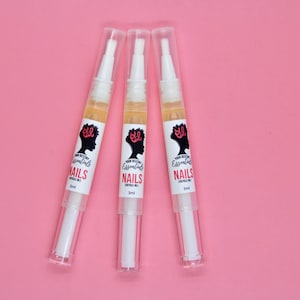 May include: Three white tubes of cuticle oil with black and white labels. The labels read "Your Beauty Essentials" and "NAILS Cuticle Oil 3ml".