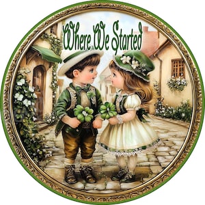 May include: A round, framed painting of two children dressed in green and white, holding shamrocks. The painting is set in a whimsical, village-like scene with a sign that reads "Where We Started".