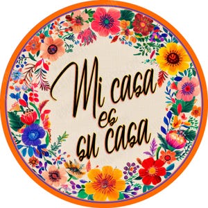 May include: A round, orange-rimmed sign with a floral border and the text "Mi casa es su casa" in black lettering.