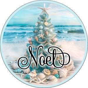 May include: A circular graphic featuring a light blue Christmas tree decorated with seashells and starfish on a sandy beach with ocean waves in the background. The word Noel is written in large, black, cursive script across the center of the image.