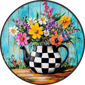 May include: A black and white checkered teapot with a bouquet of colorful flowers, including pink, yellow, orange, and blue flowers, against a turquoise wooden background.