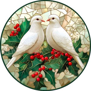 May include: A circular stained glass art piece featuring two white doves perched on a branch with bright red holly berries and dark green leaves. The background consists of a mosaic of light-colored glass segments in a geometric pattern.