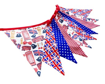 D-Day 80th Anniversary bunting with Union Jack flags, red buses and telephone boxes