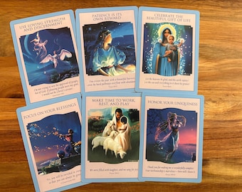 May include: Six oracle cards with light blue borders, each displaying a unique illustration and text. The cards feature phrases such as "Patience is Its Own Reward" and "Make Time to Work, Rest, and Play."