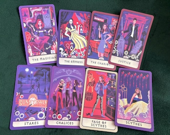 May include: A collection of tarot cards with purple borders and illustrations. The cards feature various figures and scenes, including a woman with an infinity symbol, a woman in a yellow dress, and a man with a sword. Text on the cards includes "The Magician" and "Justice."