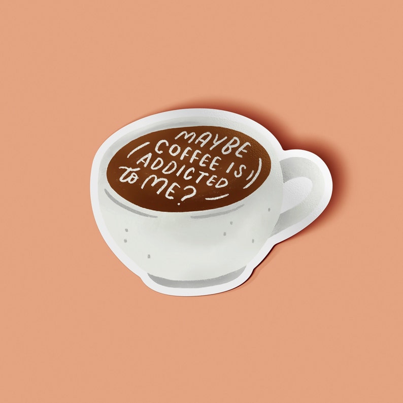 May include: A white coffee cup sticker with a brown coffee fill. The text "MAYBE COFFEE IS ADDICTED TO ME?" is written in white. The sticker is on a peach-colored background.