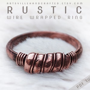 May include: A rustic copper wire wrapped ring. The ring is made from thick copper wire that has been wrapped around a smaller copper wire. The ring is a simple design, but it is very elegant.