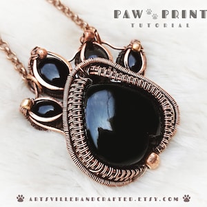 May include: A copper wire wrapped pendant featuring a black gemstone in the center and four smaller black gemstones around it. The pendant is attached to a copper chain.
