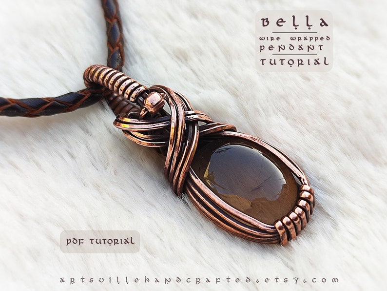 K&ouml;nnte beinhalten: Ein mit Kupferdraht umwickelter Anh&auml;nger mit einem braunen Edelstein. Der Anh&auml;nger h&auml;ngt an einer braunen Lederschnur. Der Text "bella wire wrapped pendant tutorial" steht &uuml;ber dem Anh&auml;nger. Der Text "pdf tutorial" steht unter dem Anh&auml;nger.