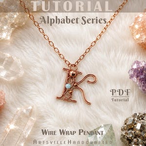 May include: A copper wire-wrapped pendant in the shape of the letter K, suspended from a matching copper chain. The pendant features intricate wire coils and a small light blue bead. Text reads: TUTORIAL Alphabet Series, PDF Tutorial, Wire Wrap Pendant, ArtsvilleHandcrafted.