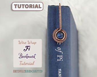May include: A handmade copper wire bookmark with a blue gemstone, inserted into a blue book. The bookmark has a circular design around the gemstone. The image also includes the text "Tutorial" and "Wire Wrap Fi Bookmark Tutorial".