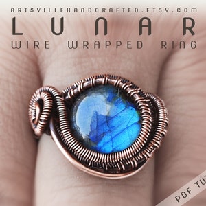 May include: A copper wire wrapped ring with a blue gemstone. The ring is on a finger. The text "LUNAR WIRE WRAPPED RING" is at the top of the image. The text "PDF TUTORIAL" is at the bottom of the image.