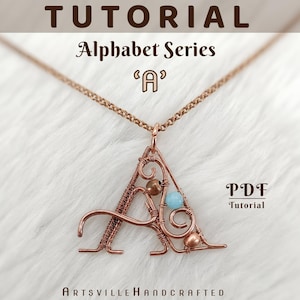 Op de afbeelding: Koperdraad hangerketting in de vorm van de letter "A", versierd met kralen. De ketting hangt aan een delicate ketting. De afbeelding bevat de tekst "Tutorial Alphabet Series 'A' PDF Tutorial Artsville Handcrafted".