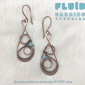 May include: A pair of copper wire earrings with a teardrop shape and a small blue bead. The earrings are handmade and have a delicate, fluid design.