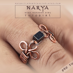 May include: A copper wire wrapped ring with a black stone. The ring is on a finger and the text "NARYA wire wrapped ring TUTORIAL" is above the ring. The text "PDF TUTORIAL" is in the bottom right corner of the image.