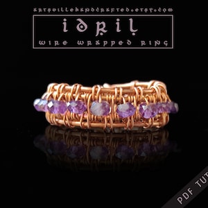 May include: A copper wire wrapped ring with a row of amethyst gemstones. The ring is on a black background and the text "idril wire wrapped ring" is above the ring.