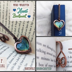 May include: A copper wire wrapped heart bookmark with a green and blue iridescent stone. The bookmark is shaped like a treble clef and is shown on a book.
