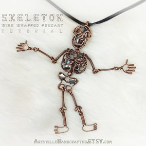May include: A wire wrapped skeleton pendant tutorial. The pendant is made of copper wire and features a skull with a black stone in the center. The skeleton is posed in a standing position with arms outstretched.
