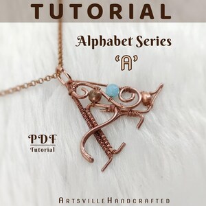 May include: Copper wire pendant in the shape of the letter "A" with decorative swirls and beads. The pendant is part of the "Alphabet Series" and is displayed on a chain. The image also includes the text "Tutorial" and "PDF Tutorial".