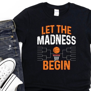 May include: Black t-shirt with an orange and white graphic that says "Let the Madness Begin" with a basketball and a bracket graphic.