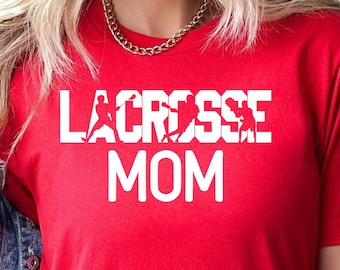 May include: Red t-shirt with white text that reads "Lacrosse Mom" with a lacrosse player graphic.