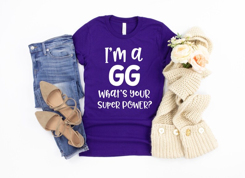 May include: Purple t-shirt with white text that reads "I'm a GG What's your super power?"