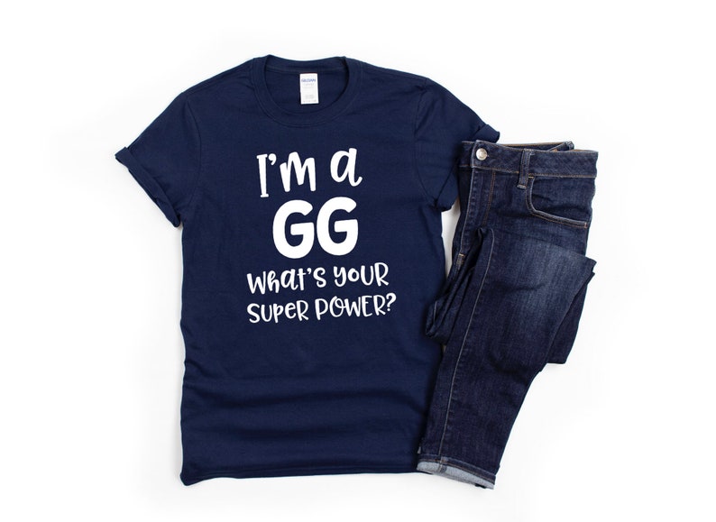 May include: A navy blue t-shirt with white text that reads "I'm a GG What's your super power?"