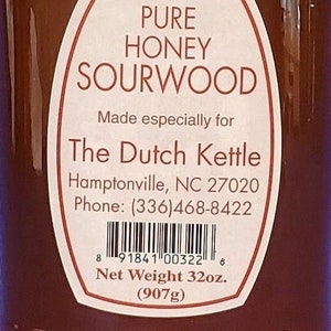 May include: A glass jar of pure honey sourwood, labeled "Pure Honey Sourwood" and made especially for "The Dutch Kettle". The label also includes the address "Hamptonville, NC 27020" and phone number "(336)468-8422". The net weight is 32 ounces (907 grams).