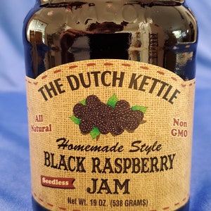 May include: A glass jar of The Dutch Kettle Homemade Style Black Raspberry Jam, seedless, all natural, non-GMO, with a net weight of 19 oz (538 grams).