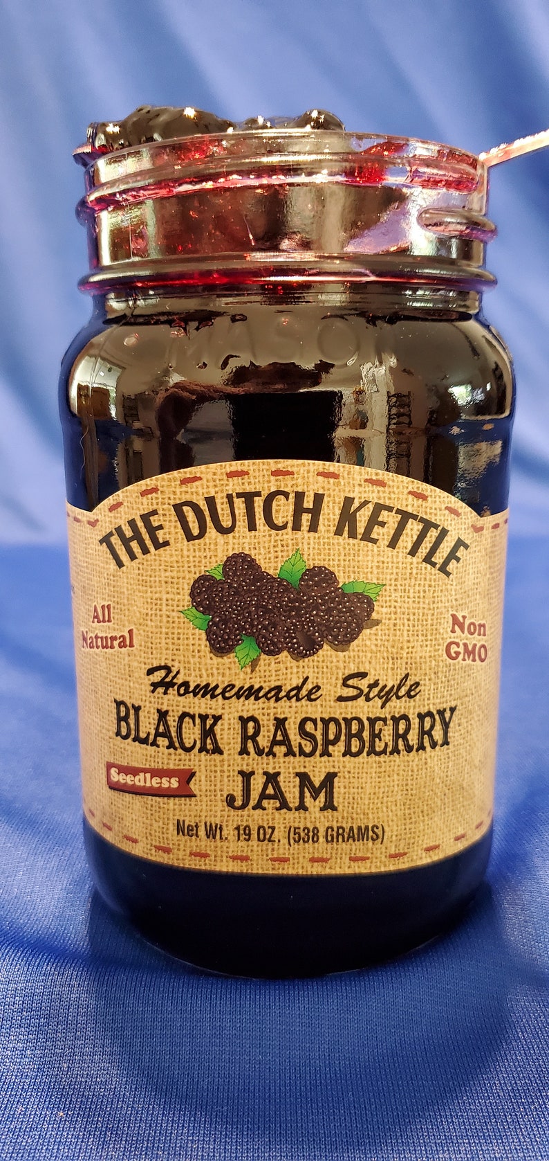 May include: A glass jar of The Dutch Kettle Homemade Style Black Raspberry Jam, seedless, all natural, non-GMO, with a net weight of 19 oz (538 grams).