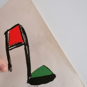 May include: A black and white abstract art print with a red and green musical note. The note is outlined in black and filled in with red and green.