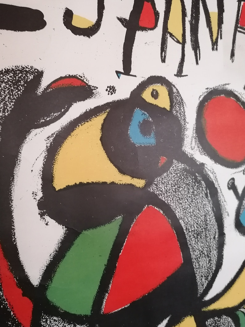 May include: Abstract art print featuring a black, yellow, red, green, and blue design. The print has a textured, hand-painted look.