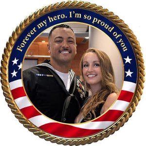 May include: A circular frame featuring a gold rope border and the American flag pattern. The text "Forever my hero. I'm so proud of you" is printed in gold along the top. Inside the circle is a photograph of a sailor in uniform and a woman.