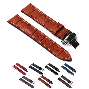 Puede incluir: Un conjunto de diez correas de reloj de cuero en varios colores, incluyendo marrón, rojo, negro, gris y azul. Las correas están hechas de cuero genuino y tienen un patrón de cocodrilo. Las correas se muestran con una hebilla plateada.