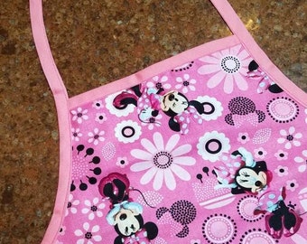 Minnie Mouse children's cotton apron with a bright pink background