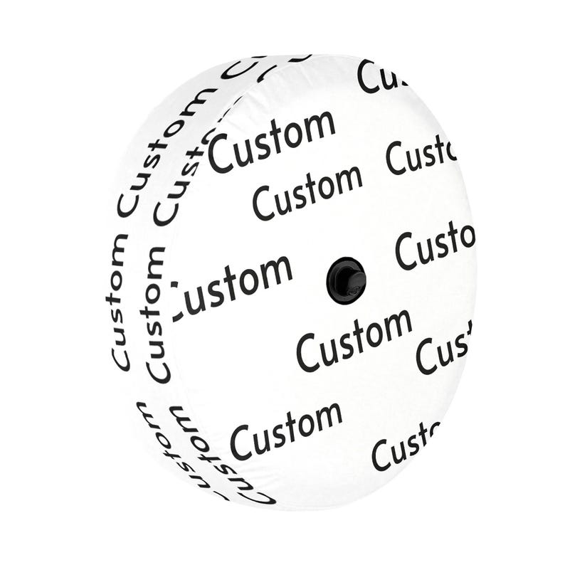 May include: A circular white spare tire cover featuring a repeating pattern of the word Custom printed in black text. The cover has a smooth, rounded surface with a small black circular attachment point located in the center of the design.