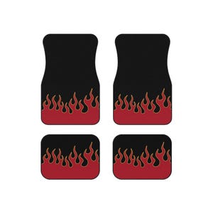 May include: A set of four black car floor mats featuring a red flame pattern along the bottom edge. The two larger mats have a contoured shape, while the two smaller mats are rectangular with rounded corners, all displaying identical fire graphics.