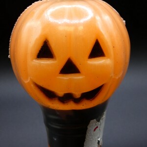 May include: Orange plastic jack-o'-lantern shaped Halloween light with a black stem and a white label that says "Halloween Classic".