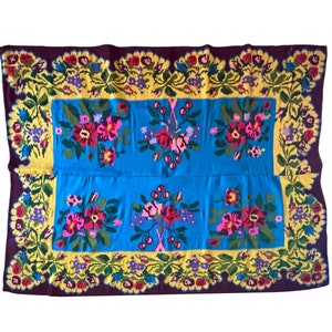 Floral wool vintage rug on blue and yellow background made by hand in Transylvania