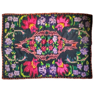 Bohemian handwoven wool rug, black background with colorful floral design