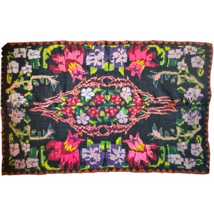 Bohemian floral design, handwoven wool rug, black background with colorful flowers