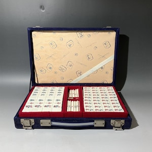 a mahjong game set in a grey room